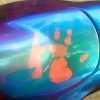 John Haro's handprint on his thermochromic pigment painted motorcycle tank. Temperature changing chameleon!.